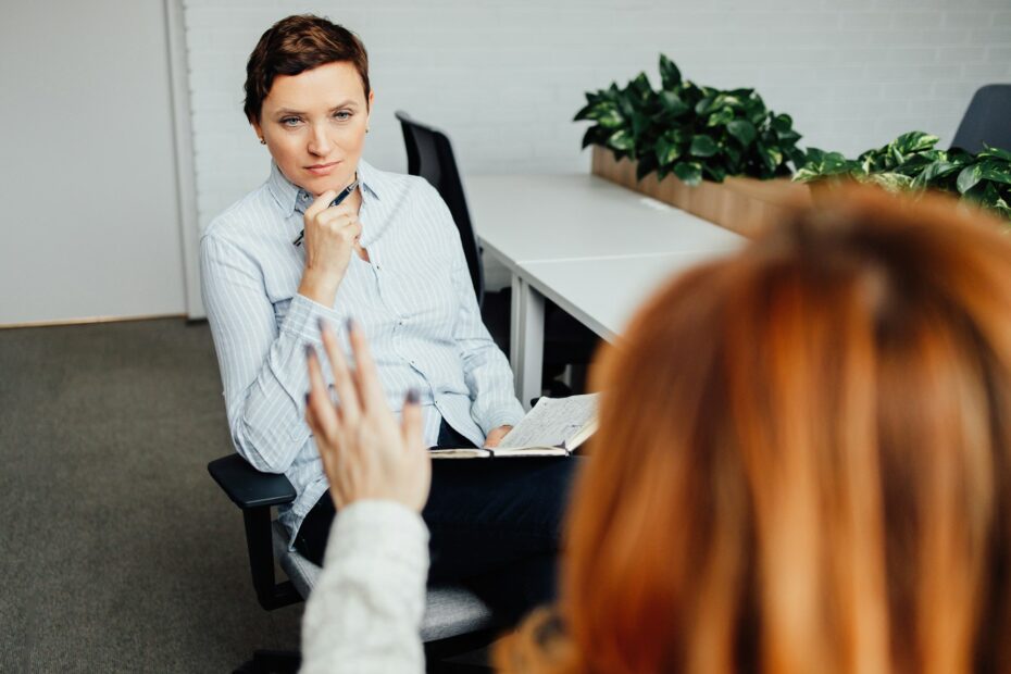 A psychologist meets with a client in the office